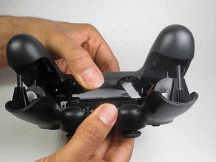 Split apart the controller’s plastic cover as shown in the below image